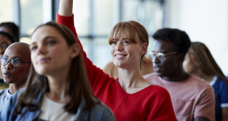 UNO Student Raising Her Hand in Class