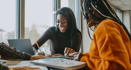 2 Students Happily Studying Together